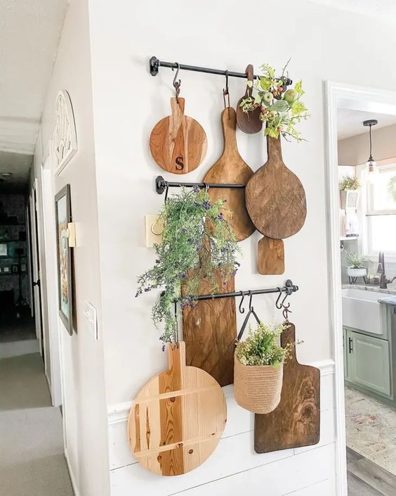 hanging wooden cutting boards on the kitchen wall